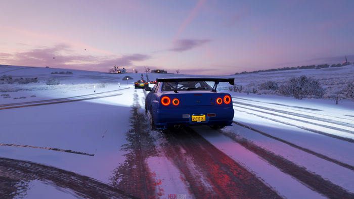 Blue Nissan Skyline GT-R R34 driving in snow in Forza Horizon 4