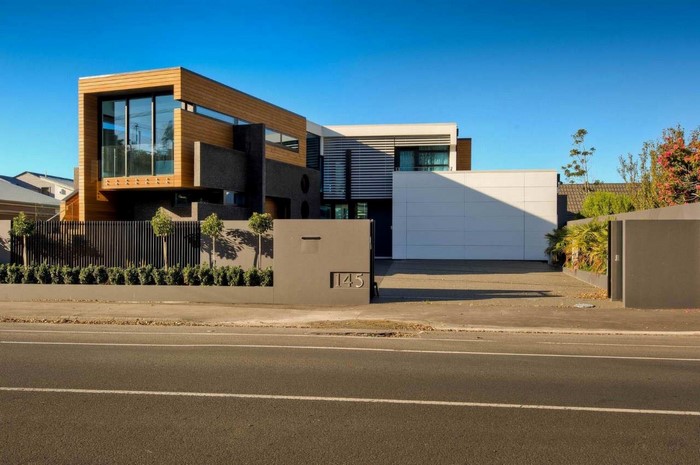 Modern mansion with wooden and dark stone facade