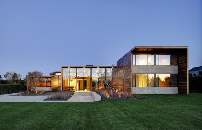 Modern mansion with glass walls and wood exterior