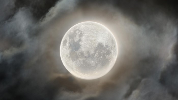 Full moon surrounded by clouds