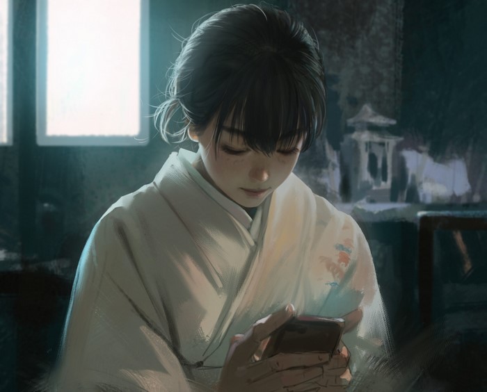 Asian woman in kimono looking at cellphone