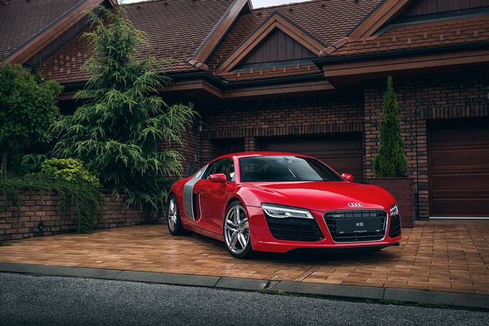 Red Audi R8 parked in front of a house