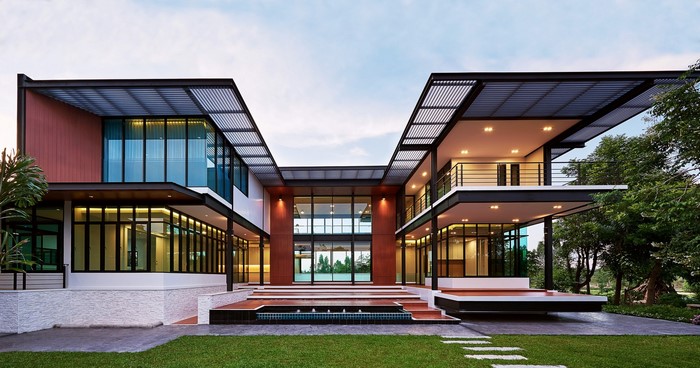 Modern multi-story house with large windows and a courtyard