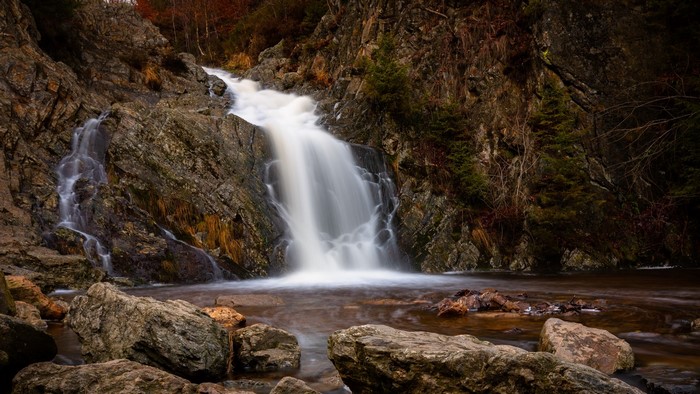 Waterfall cascading over rocks in a forest