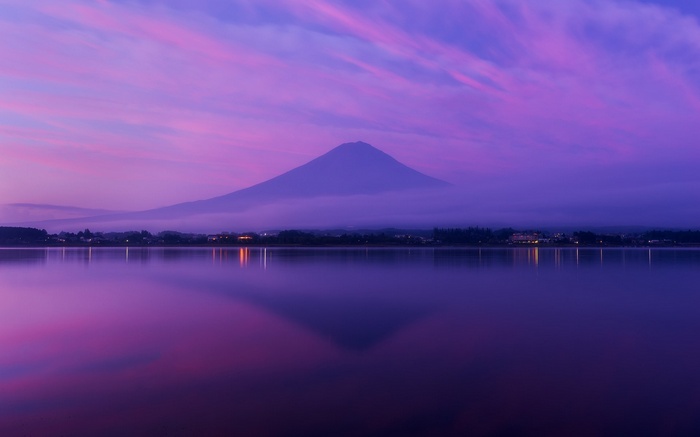 Mount Fuji reflected in a lake at twilight