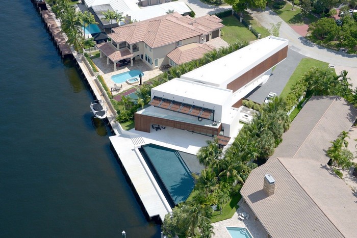 Modern waterfront house with pool and boat dock