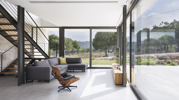 Modern living room with stairs and large windows
