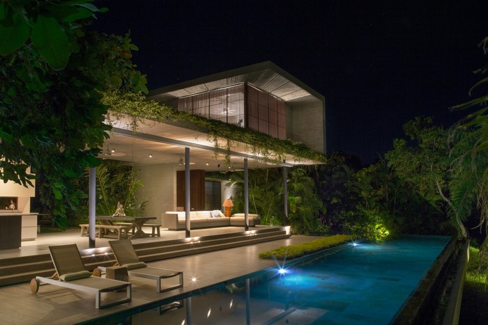 Modern house with swimming pool at night