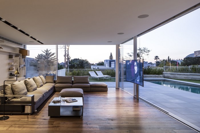 Modern living room with sectional sofa and pool view