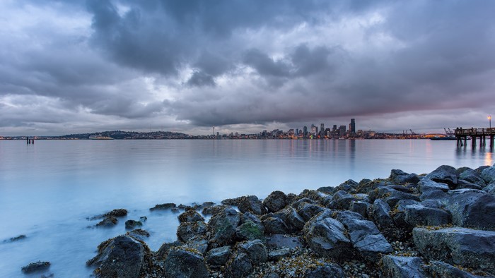 Seattle Cityscape with Rocky Shoreline and Cloudy Sky