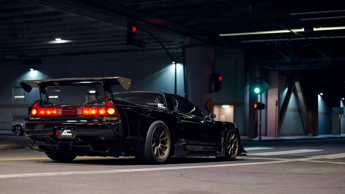 Black Honda NSX mk1 with large rear wing at night
