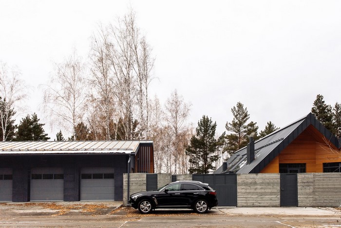 Modern garage and house with a black car