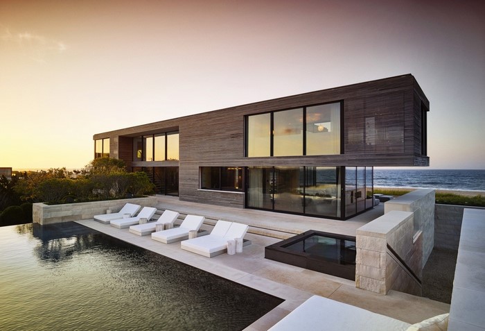Modern luxury mansion with swimming pool at dusk