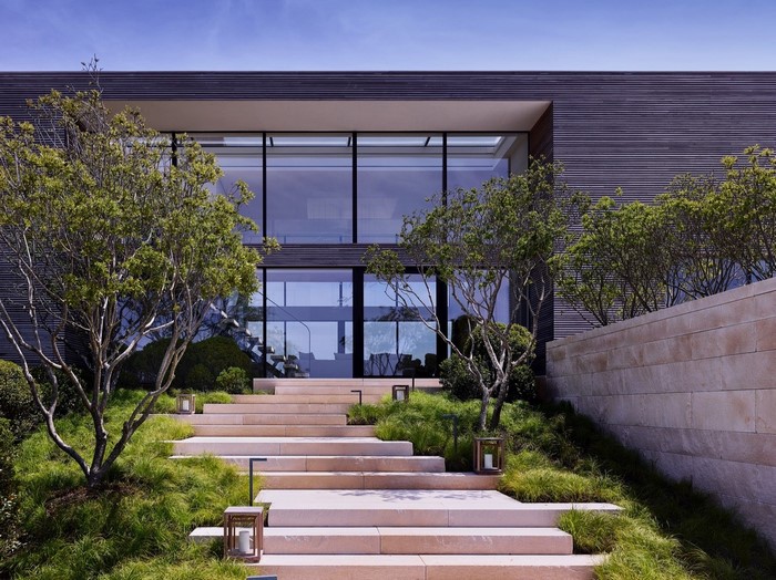 Modern house with large glass windows and stone steps
