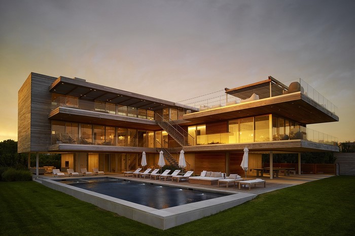 Modern mansion with swimming pool at sunset