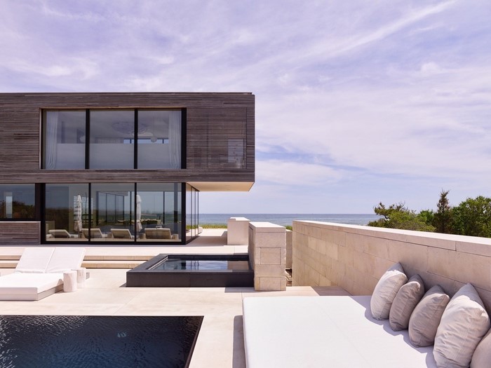 Modern wooden house with swimming pools and ocean view