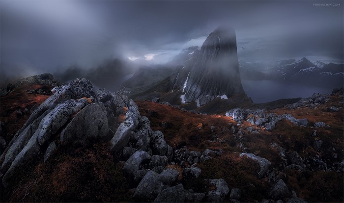 Dark rocky mountain landscape with fog