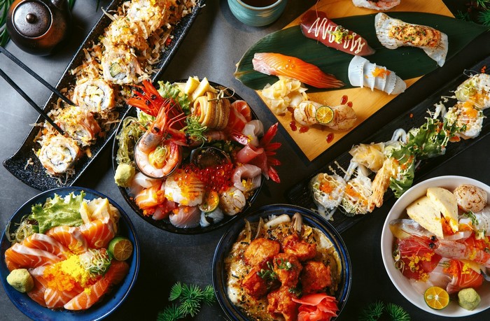 Assortment of sushi, sashimi, and seafood dishes