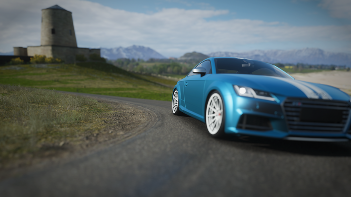 Blue Audi TT with white stripes on a road