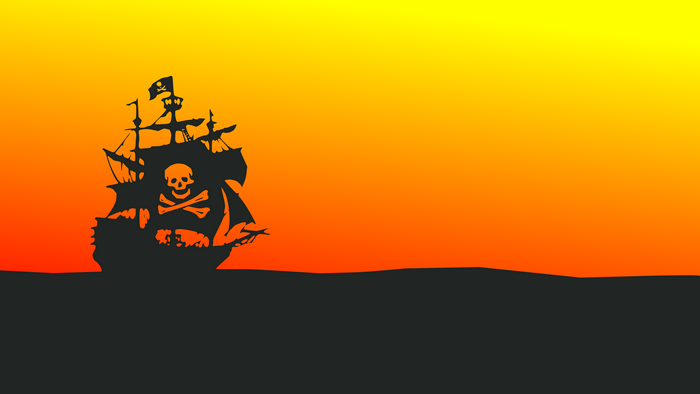 Pirate ship with Jolly Roger flag sailing at sunset