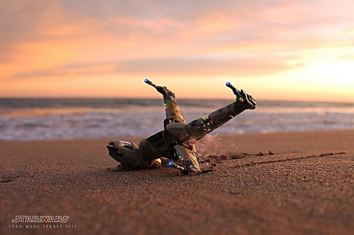 Star Wars B-wing toy crashed on a beach at sunset