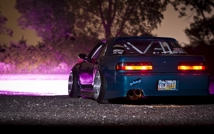 Blue modified car with custom license plate at night
