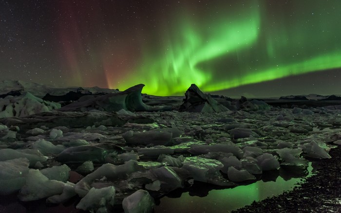 Aurora Borealis over icebergs at night