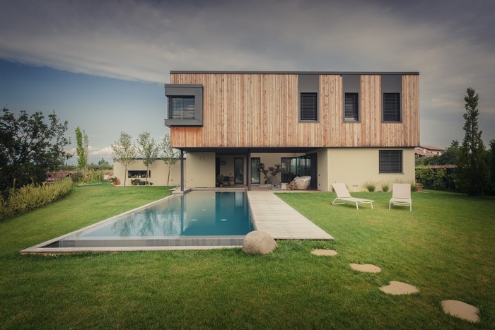 Modern house with swimming pool and lounge chairs
