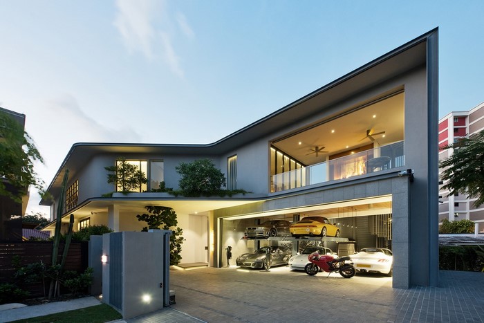 Modern luxury house with multi-level garage and cars