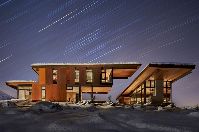 Modern house with star trails in the snow