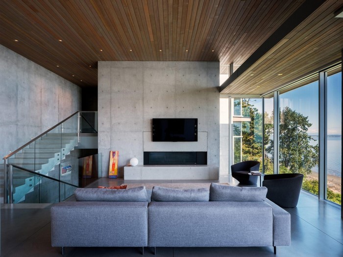 Modern living room with concrete walls and wooden ceiling