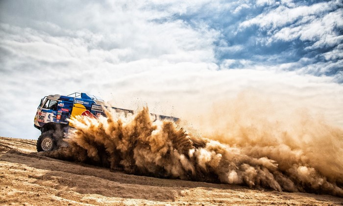 Kamaz truck racing through dust