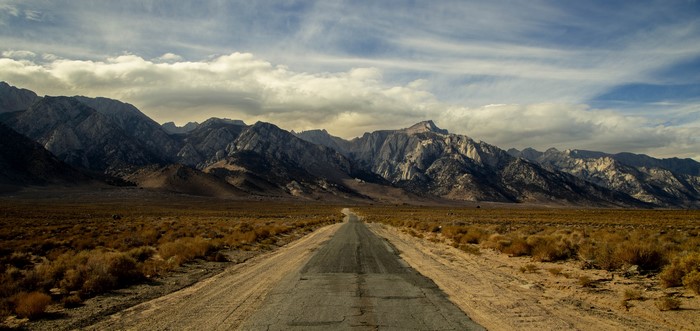 Road leading to mountains landscape