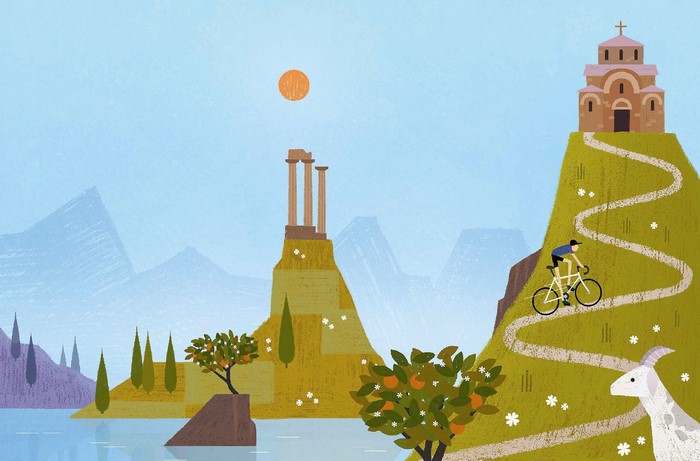 Cyclist on a mountain path near ancient ruins and a church