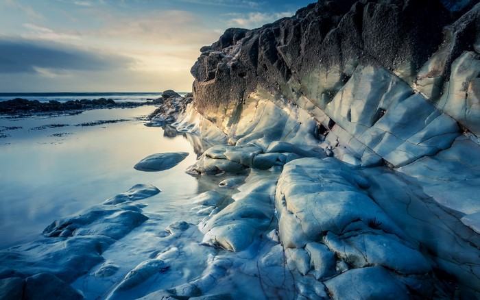 Rocky coast with calm water at sunset
