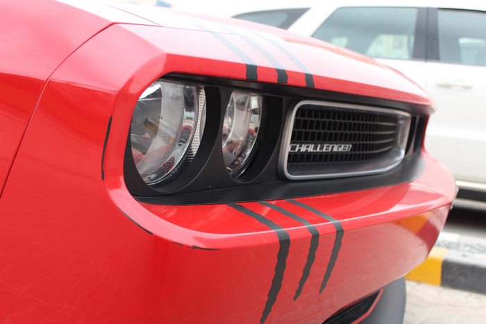 Red Dodge Challenger R/T with racing stripes