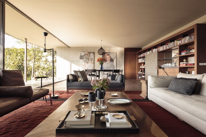 Modern living room with sofas, coffee table, and bookshelf