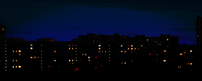 Apartment buildings at night with illuminated windows