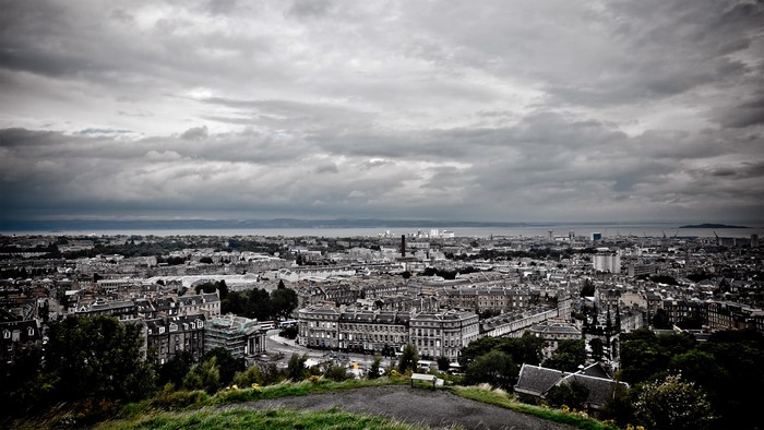 Cityscape with dramatic clouds over buildings and water