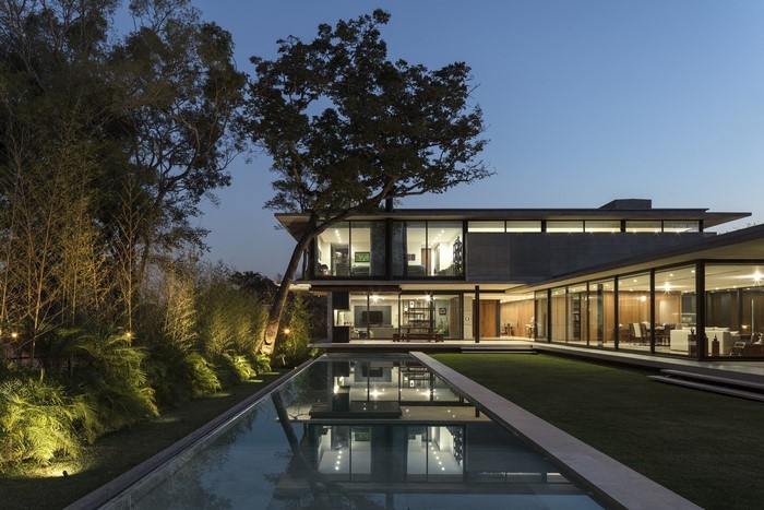 Modern mansion with swimming pool at dusk