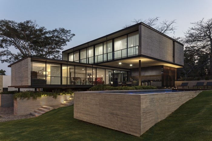 Modern concrete house with swimming pool at dusk