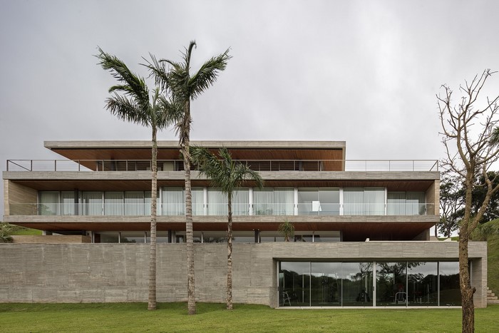 Modern concrete mansion with palm trees