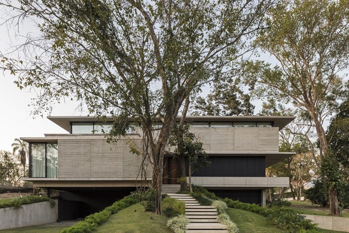 Modern concrete house with large trees