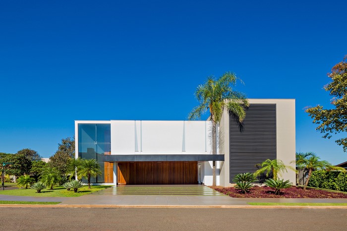 Modern mansion with large wooden doors and glass windows