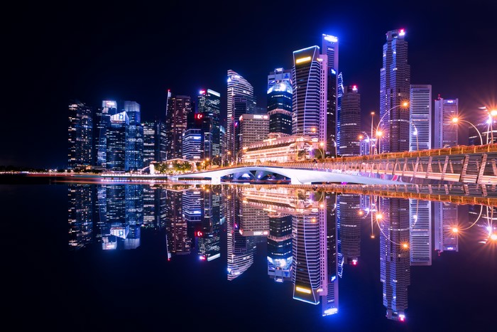 Singapore skyline at night with reflections