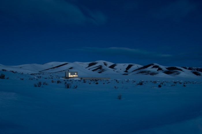Modern house in a snowy landscape at dusk