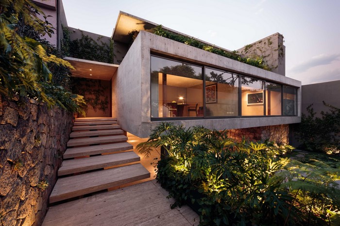 Modern concrete house with stone wall and stairs