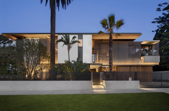 Modern mansion with palm trees at dusk