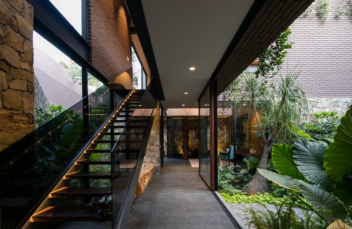 Modern house interior with indoor garden and staircase