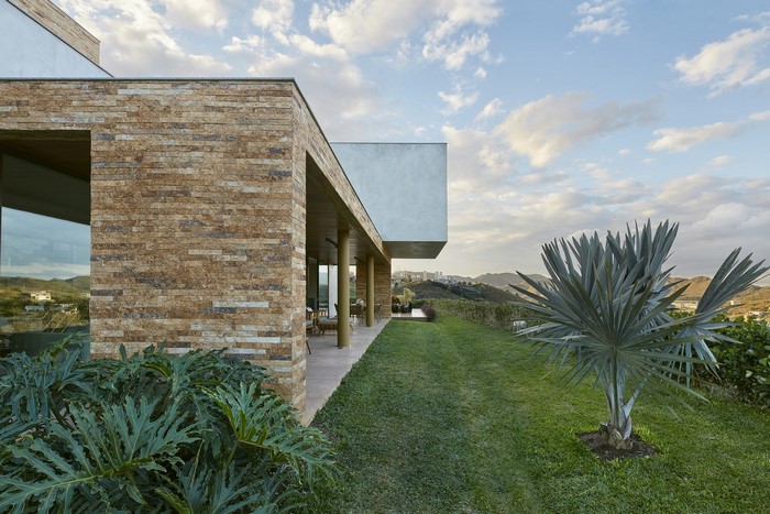Modern house with stone facade and garden